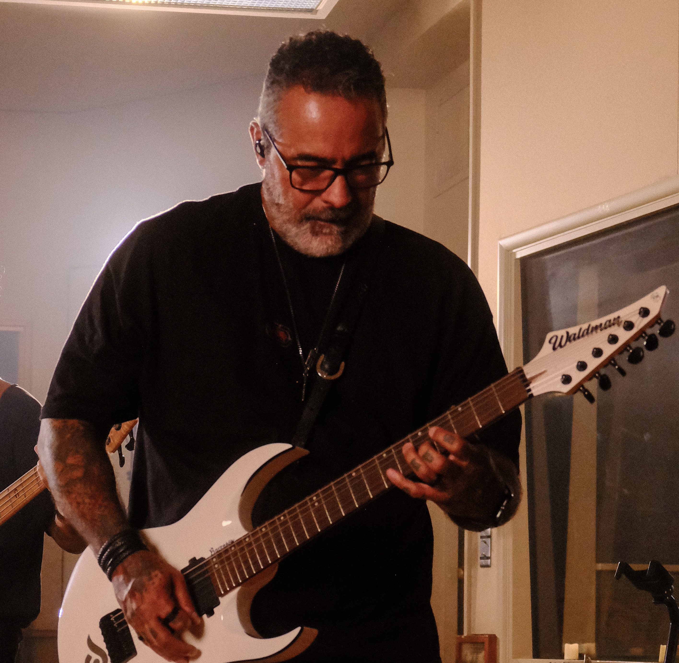 Deio performing on guitar in the studio